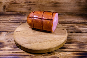 Cutting board with sausage on wooden table