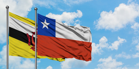 Brunei and Chile flag waving in the wind against white cloudy blue sky together. Diplomacy concept, international relations.