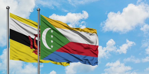Brunei and Comoros flag waving in the wind against white cloudy blue sky together. Diplomacy concept, international relations.