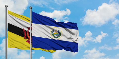 Brunei and El Salvador flag waving in the wind against white cloudy blue sky together. Diplomacy concept, international relations.
