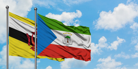 Brunei and Equatorial Guinea flag waving in the wind against white cloudy blue sky together. Diplomacy concept, international relations.