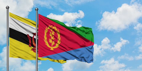 Brunei and Eritrea flag waving in the wind against white cloudy blue sky together. Diplomacy concept, international relations.