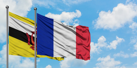 Brunei and France flag waving in the wind against white cloudy blue sky together. Diplomacy concept, international relations.