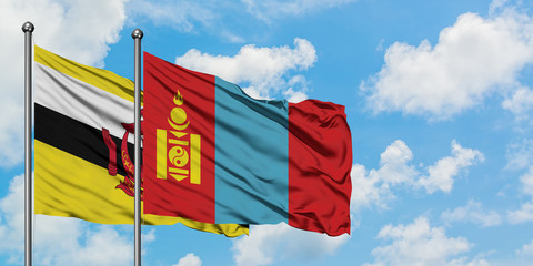 Brunei and Mongolia flag waving in the wind against white cloudy blue sky together. Diplomacy concept, international relations.