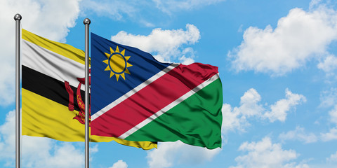 Brunei and Namibia flag waving in the wind against white cloudy blue sky together. Diplomacy concept, international relations.