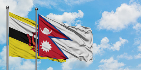 Brunei and Nepal flag waving in the wind against white cloudy blue sky together. Diplomacy concept, international relations.