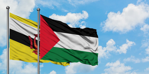 Brunei and Palestine flag waving in the wind against white cloudy blue sky together. Diplomacy concept, international relations.