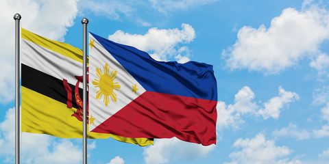 Brunei and Philippines flag waving in the wind against white cloudy blue sky together. Diplomacy concept, international relations.