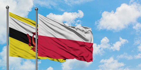 Brunei and Poland flag waving in the wind against white cloudy blue sky together. Diplomacy concept, international relations.