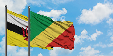Brunei and Republic Of The Congo flag waving in the wind against white cloudy blue sky together. Diplomacy concept, international relations.