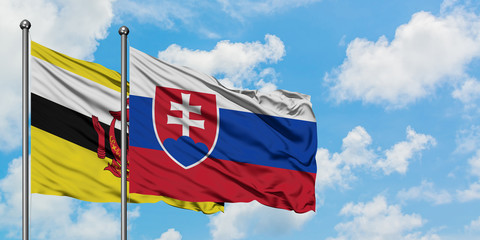 Brunei and Slovakia flag waving in the wind against white cloudy blue sky together. Diplomacy concept, international relations.