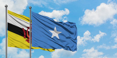 Brunei and Somalia flag waving in the wind against white cloudy blue sky together. Diplomacy concept, international relations.
