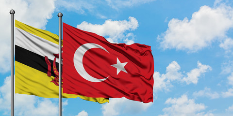 Brunei and Turkey flag waving in the wind against white cloudy blue sky together. Diplomacy concept, international relations.