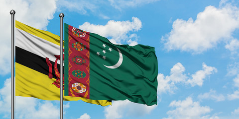 Brunei and Turkmenistan flag waving in the wind against white cloudy blue sky together. Diplomacy concept, international relations.