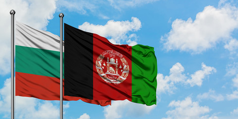 Bulgaria and Afghanistan flag waving in the wind against white cloudy blue sky together. Diplomacy...