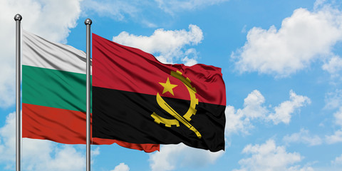 Bulgaria and Angola flag waving in the wind against white cloudy blue sky together. Diplomacy...