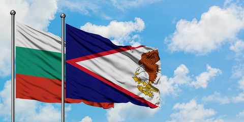 Bulgaria and American Samoa flag waving in the wind against white cloudy blue sky together....