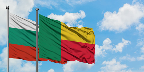 Bulgaria and Benin flag waving in the wind against white cloudy blue sky together. Diplomacy...