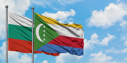 Bulgaria and Comoros flag waving in the wind against white cloudy blue sky together. Diplomacy concept, international relations.