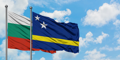 Bulgaria and Curacao flag waving in the wind against white cloudy blue sky together. Diplomacy concept, international relations.