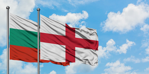 Bulgaria and England flag waving in the wind against white cloudy blue sky together. Diplomacy concept, international relations.