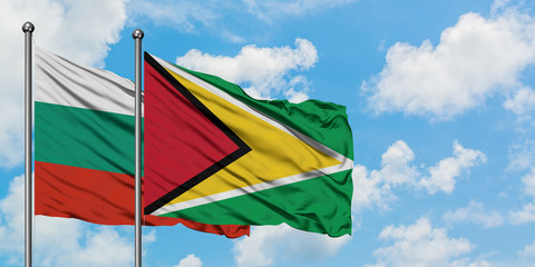 Bulgaria and Guyana flag waving in the wind against white cloudy blue sky together. Diplomacy concept, international relations.