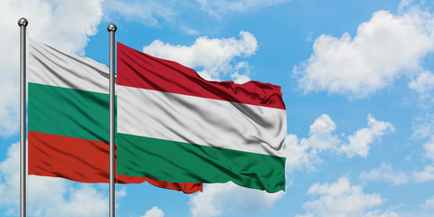 Bulgaria and Hungary flag waving in the wind against white cloudy blue sky together. Diplomacy concept, international relations.