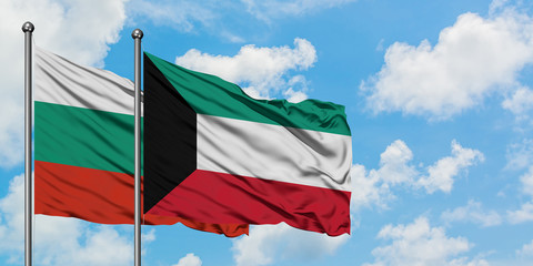 Bulgaria and Kuwait flag waving in the wind against white cloudy blue sky together. Diplomacy concept, international relations.