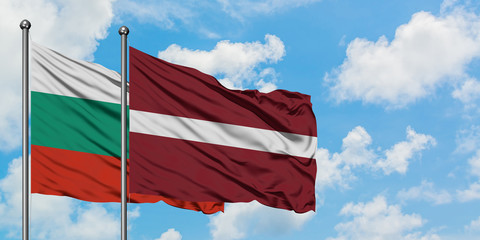 Bulgaria and Latvia flag waving in the wind against white cloudy blue sky together. Diplomacy concept, international relations.