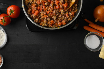 Cooking Italian lasagna, frying in a skillet dressing. Background for design. Cooking process. Top view.