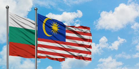Bulgaria and Malaysia flag waving in the wind against white cloudy blue sky together. Diplomacy concept, international relations.