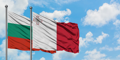 Bulgaria and Malta flag waving in the wind against white cloudy blue sky together. Diplomacy concept, international relations.
