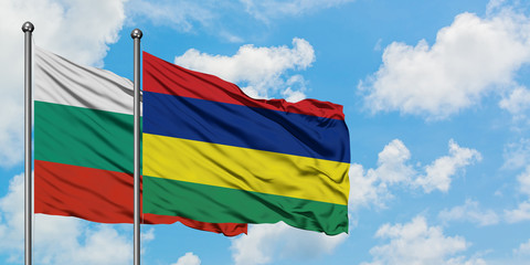 Bulgaria and Mauritius flag waving in the wind against white cloudy blue sky together. Diplomacy concept, international relations.