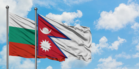 Bulgaria and Nepal flag waving in the wind against white cloudy blue sky together. Diplomacy concept, international relations.