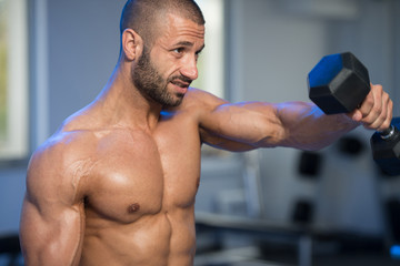 Shoulders Exercise With Dumbbells In A Gym