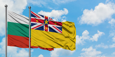 Bulgaria and Niue flag waving in the wind against white cloudy blue sky together. Diplomacy concept, international relations.