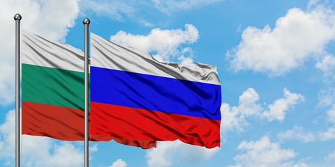 Bulgaria and Russia flag waving in the wind against white cloudy blue sky together. Diplomacy concept, international relations.