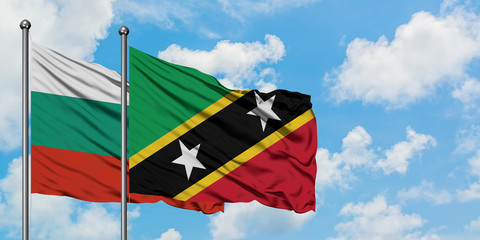 Bulgaria and Saint Kitts And Nevis flag waving in the wind against white cloudy blue sky together. Diplomacy concept, international relations.