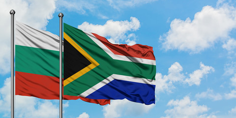 Bulgaria and South Africa flag waving in the wind against white cloudy blue sky together. Diplomacy concept, international relations.