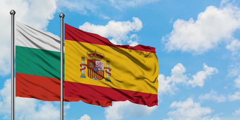 Bulgaria and Spain flag waving in the wind against white cloudy blue sky together. Diplomacy concept, international relations.