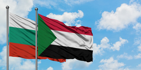 Bulgaria and Sudan flag waving in the wind against white cloudy blue sky together. Diplomacy concept, international relations.