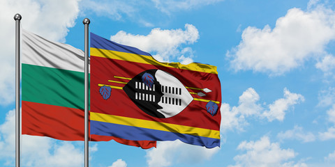 Bulgaria and Swaziland flag waving in the wind against white cloudy blue sky together. Diplomacy concept, international relations.