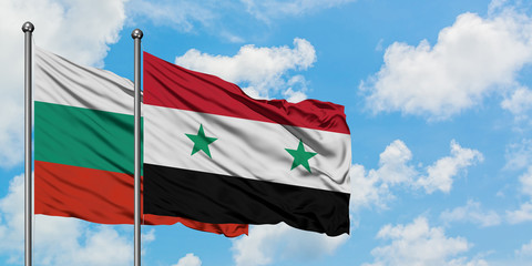 Bulgaria and Syria flag waving in the wind against white cloudy blue sky together. Diplomacy concept, international relations.