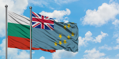 Bulgaria and Tuvalu flag waving in the wind against white cloudy blue sky together. Diplomacy...