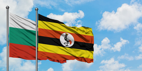 Bulgaria and Uganda flag waving in the wind against white cloudy blue sky together. Diplomacy concept, international relations.