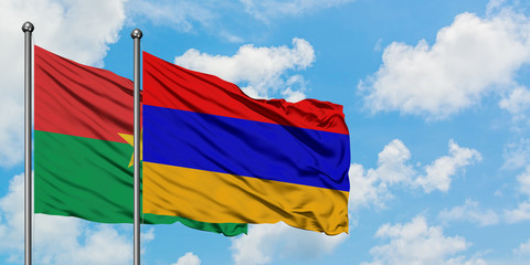 Burkina Faso and Armenia flag waving in the wind against white cloudy blue sky together. Diplomacy concept, international relations.