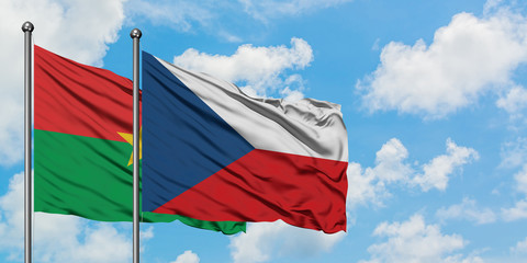 Burkina Faso and Czech Republic flag waving in the wind against white cloudy blue sky together. Diplomacy concept, international relations.