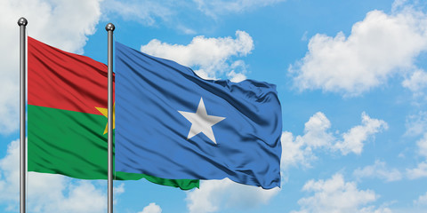 Burkina Faso and Somalia flag waving in the wind against white cloudy blue sky together. Diplomacy concept, international relations.