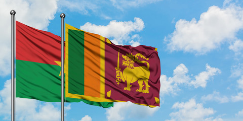 Burkina Faso and Sri Lanka flag waving in the wind against white cloudy blue sky together. Diplomacy concept, international relations.