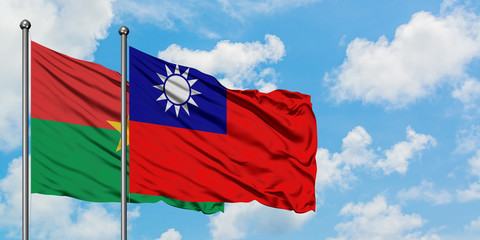 Burkina Faso and Taiwan flag waving in the wind against white cloudy blue sky together. Diplomacy concept, international relations.